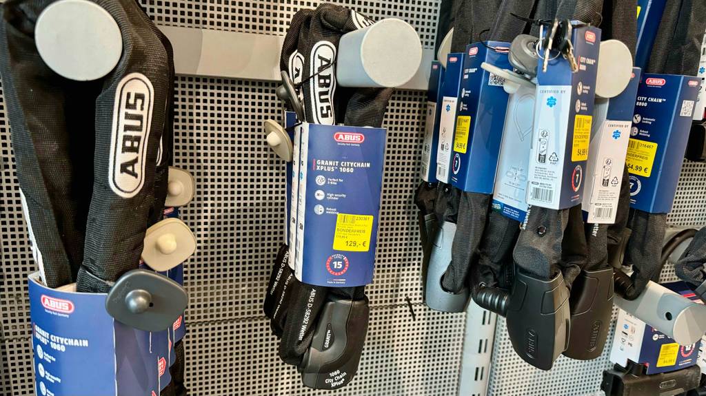 Ein getestetes E-Bike-Schloss hängt inklusive Verpackung an einem Verkaufsregal.