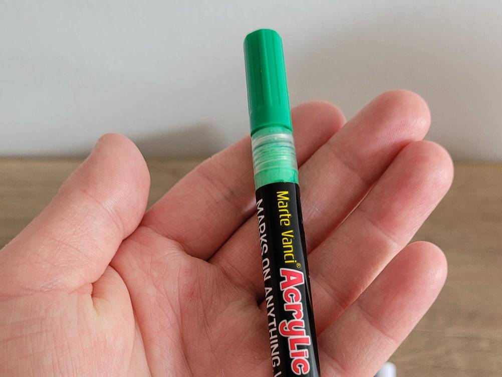 Nahaufnahme der Kappe eines getesteten Acrylstifts in einer Hand.