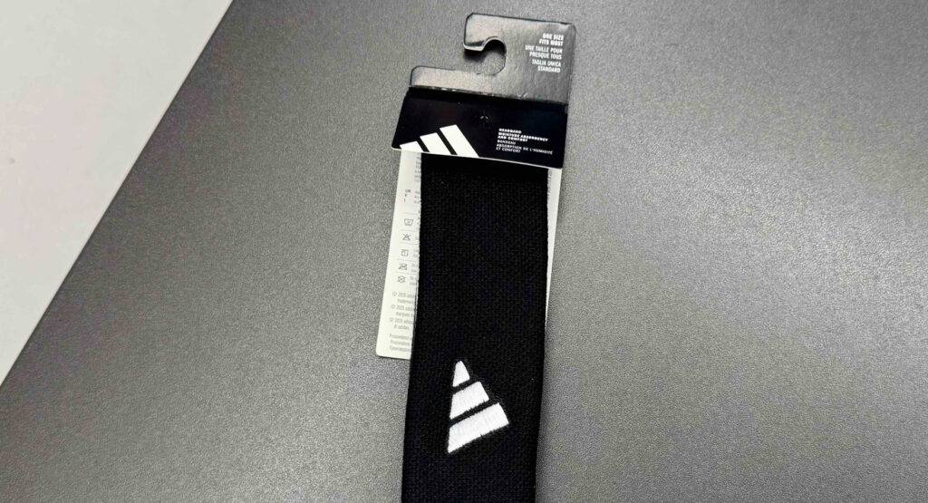 Nahaufnahme des ADIDAS-Markenzeichens auf dem schwarzen getesteten Stirnbands.