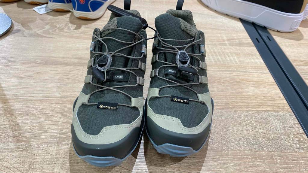 Niedrige anthrazitfarbene Damen-Trekkingschuhe im Test stehen mit Fokus auf die Zehenschutzkappen auf einem hellen Holzboden.