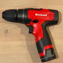 Einhell TH-CD 12-2 Li Akkuschrauber liegt seitlich auf einer Tischfläche. Griff, Bohrfutter und Gehäuseform sind vollständig sichtbar.