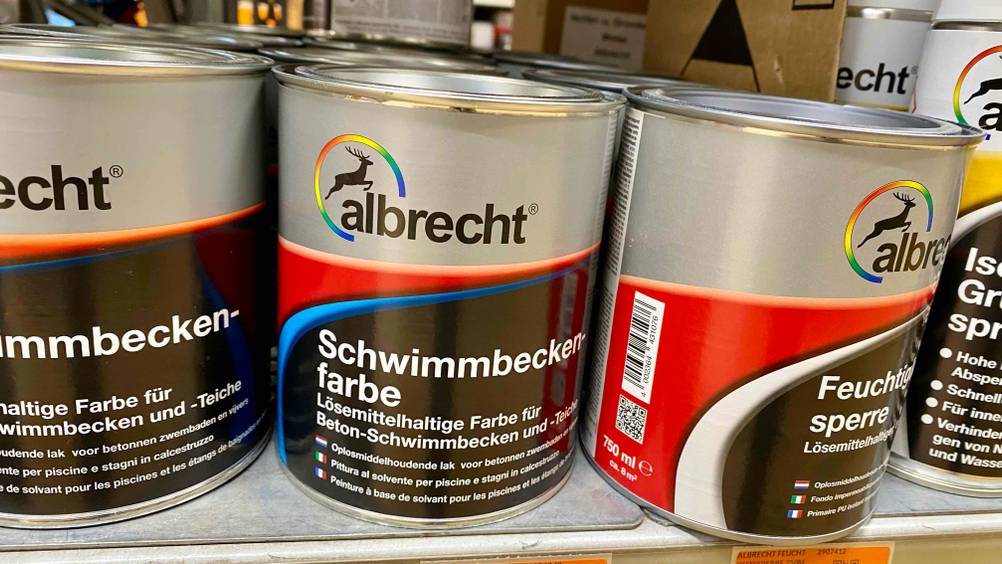 Schwimmbadfarbe im Test: Einige Produkte stehen nebeneinander.