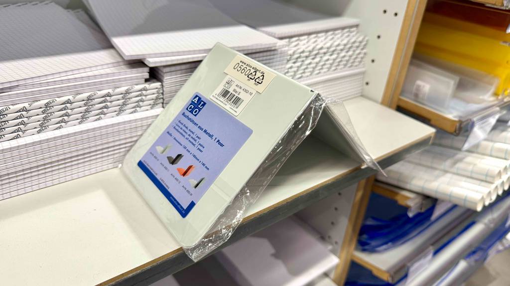 Eine verpackte Buchstütze steht vor mehreren gestapelten Blöcken.