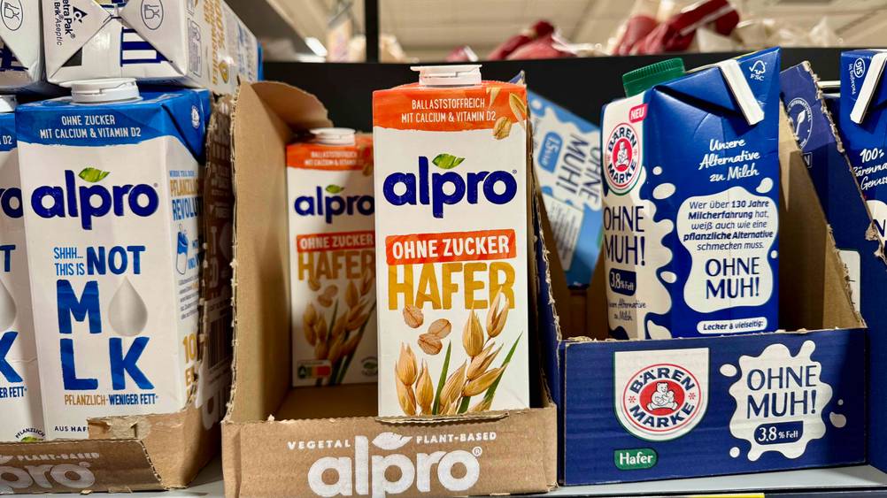 Alpro-Haferdrink im Test: In einem Regal stehen mehrere Packungen neben anderen Produkten.
