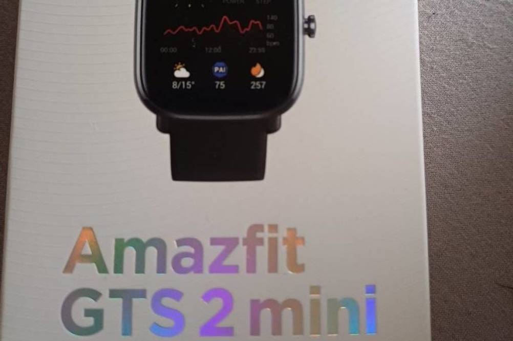 Amazfit GTS 2 Mini EKG-Uhr im Test: Nahaufnahme der Originalverpackung, auf der die Funktionen der Uhr im schwarzen Design zu sehen sind.