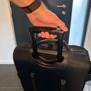 Eine Hand hält die Amazon Basics Ripstop am ausgefahrenen Griff fest.