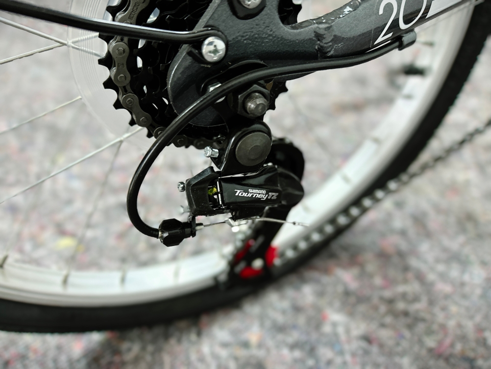 Das Bild zeigt die verbaute Shimano-Tourney-TZ-Gangschaltung am Hinterrad des Anakon Tender. Das Schaltwerk liegt unterhalb des Kettenblatts.