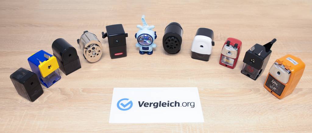Anspitzer-mit-Kurbel-Test: Alle Anspitzer aus dem Test auf einem Bild mit dem Schild von Vergleich.org.