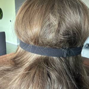 Der Hinterkopf einer Person, die die Aosun-Seiden-Schlafmaske trägt.