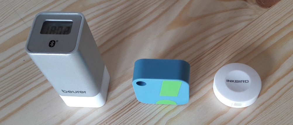 Drei smarte Hygrometer auf einem Holzbrett