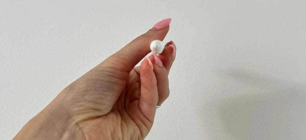 Hand hält den getesteten Tablet-Stift mit der Spitze zum Kameraobjektiv.