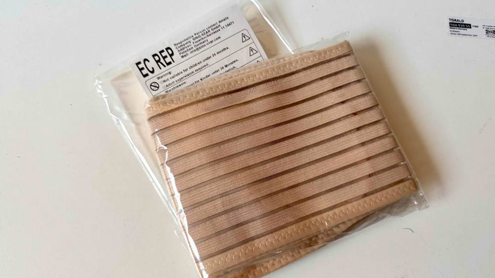 Ein transparent verpackter Bauchgurt Schwangerschaft im Test auf einer hellen Fläche.