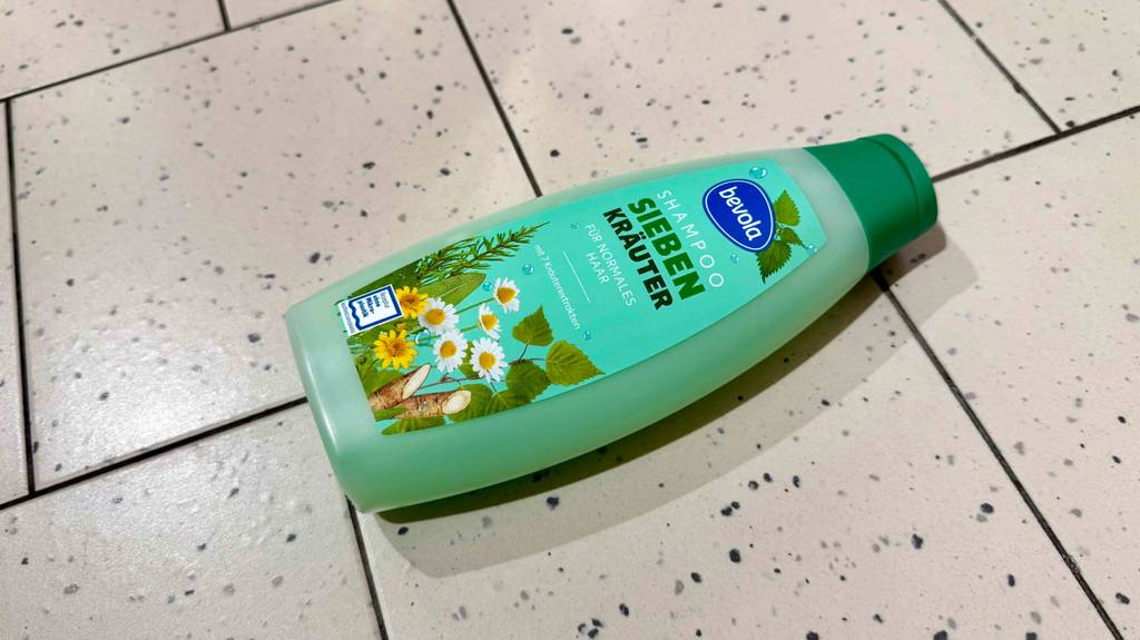 Eine Kunststoffflasche mit getestetem Kräuter-Shampoo liegt auf dem Boden.