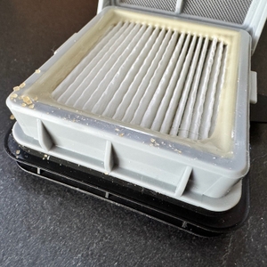 Einer der Filter des Bissell CrossWave C3 Pro nach dem Aufsaugen von braunem Zucker in Nahaufnahme