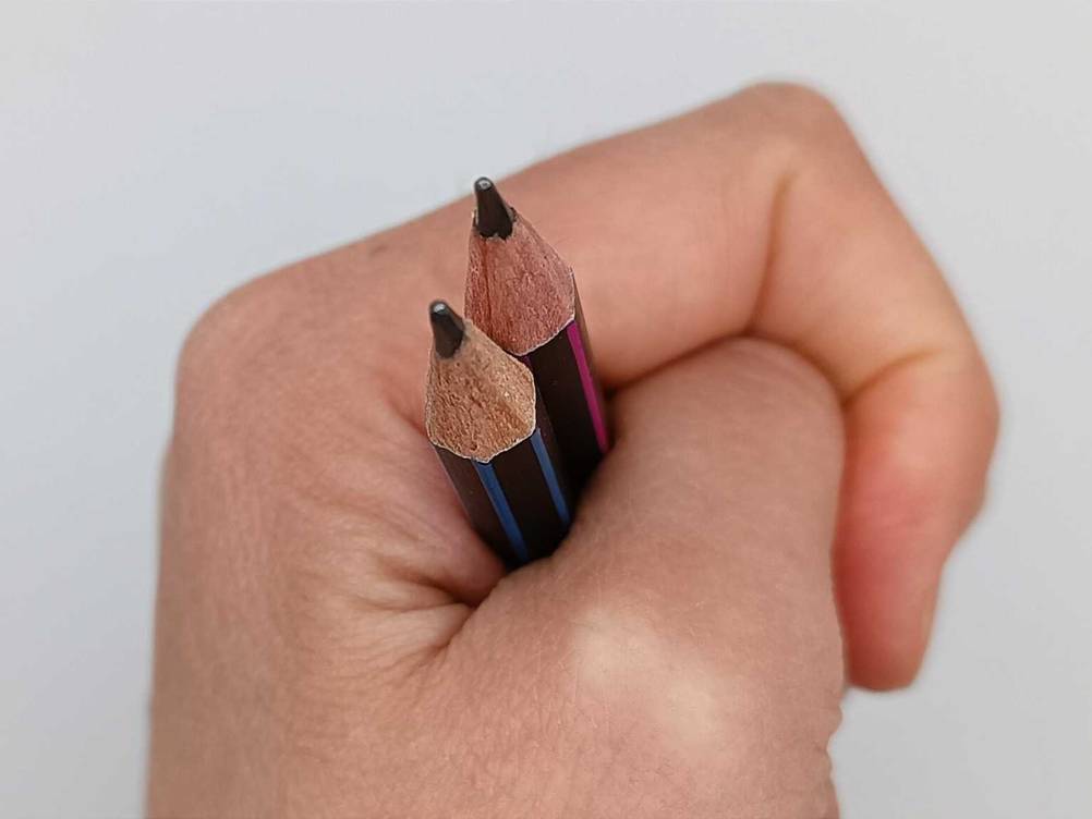 Bleistift getestet: Nahaufnahme der Spitzen von zwei Stiften von einer Hand festgehalten.