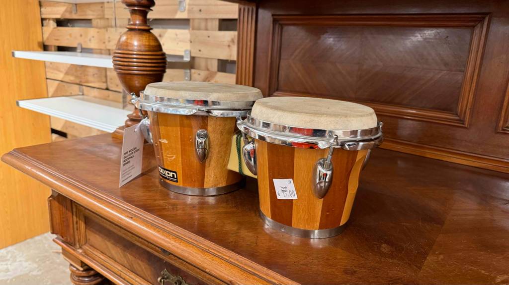 Bongo getestet: Die Trommeln von schräg seitelich auf einem Holzregal.