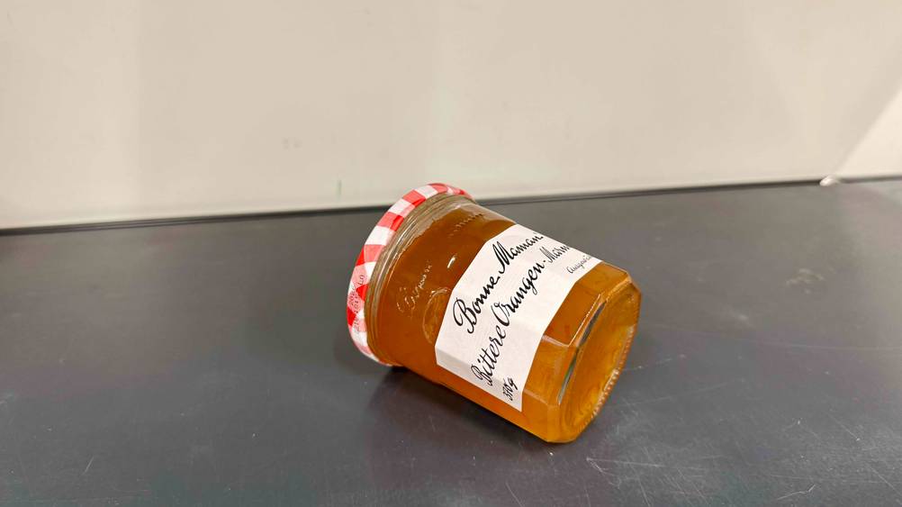 Auf einer grauen Fläche liegt ein Glas Bonne-Maman-Marmelade im Test.