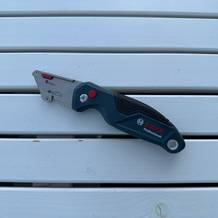 Das Bosch Professional 1600A016BL liegt ausgeklappt auf einem Holztisch