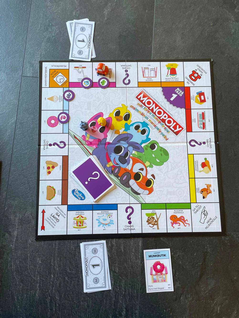 Im Test: Das aufgebaute Brettspiel Monopoly auf einem dunklen Boden.