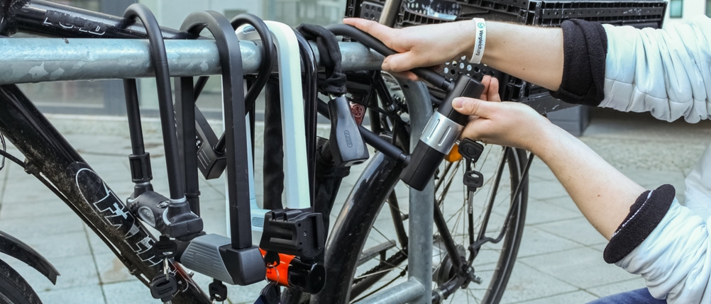 Ein Fahrrad wird mit einem Bügelschloss gesichert
