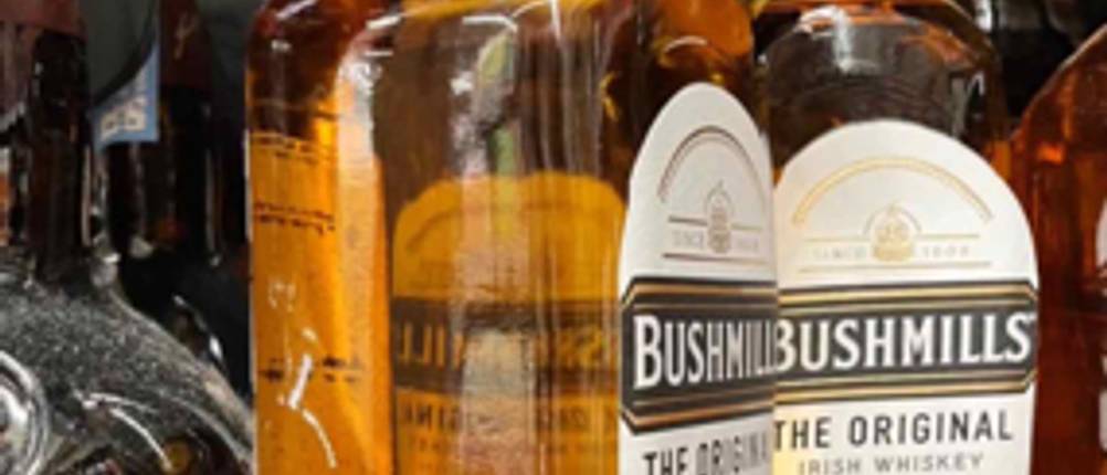 Irischer Whiskey im Test: Eine Flasche Bushmills steht quer vor einer zweiten.