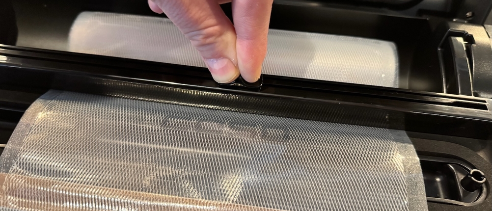 Zwei Finger drücken Knopf beim Caso FastVac 500