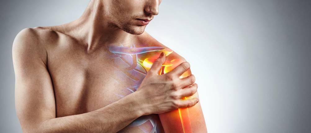 Man holding his injured shoulder that's highlighted in red. Medical concept.