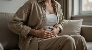 Cistus-Kapseln-Test: Eine Frau umfasst mit beiden Händen Ihren Bauch. 