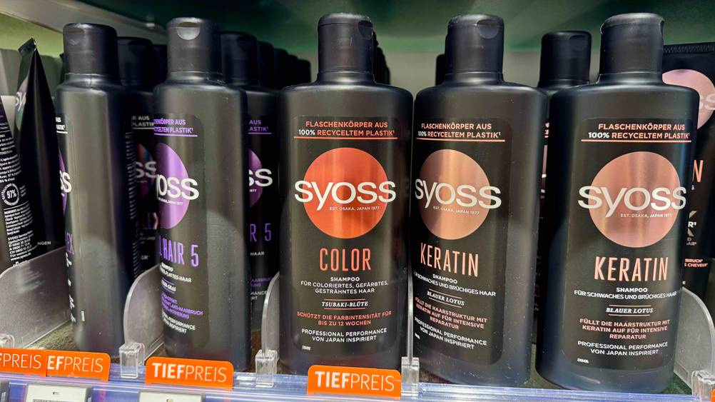 In einem Verkaufsregal stehen mehrere Flaschen des getesteten Color-Shampoos neben anderen Produkten.