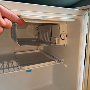 Eine Hand öffnet das Tiefkühlfach des Comfee-RCD50WH2(E)-Mini-Kühlschranks.