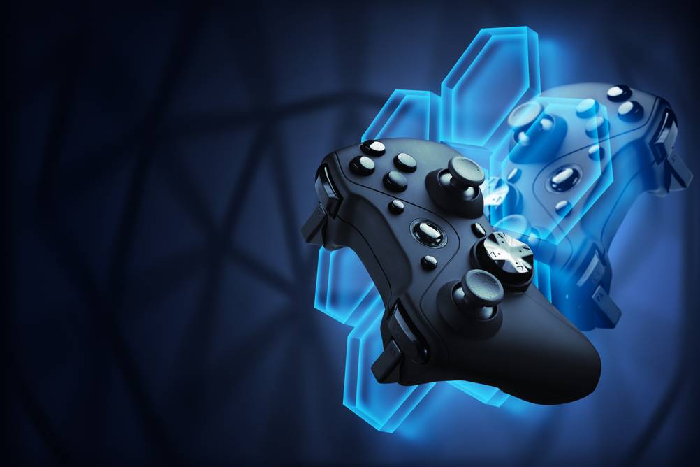PS5-Spiele im Test: Ein schwarzes Gamepad befindet sich vor einem Wabenmuster, das in einen schwarzen Hintergrund übergeht. Hinter dem Waben befindet sich eine Spiegelung des Pads.