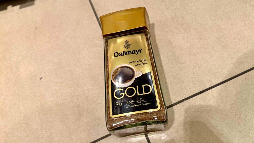 Auf einem hellen Boden liegt ein Glas des Dallmayr-Kaffees im Test.