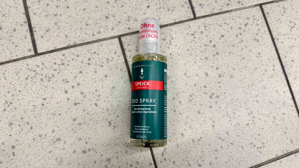 Deo ohne Aluminium-Test: Eine Flasche von schräg oben auf einem Fließenboden.