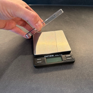 Eine Hand hebt einen durchsichtigen Schutz von der Dipse 6096 hoch