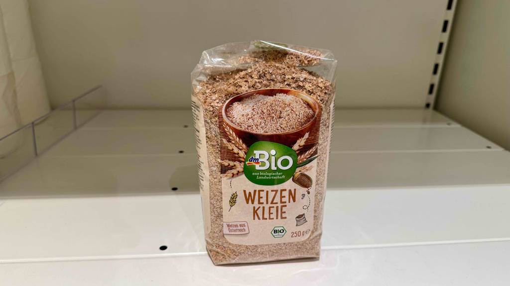 Eine Packung getestete Weizenkleie steht in einem leeren weißen Regal.