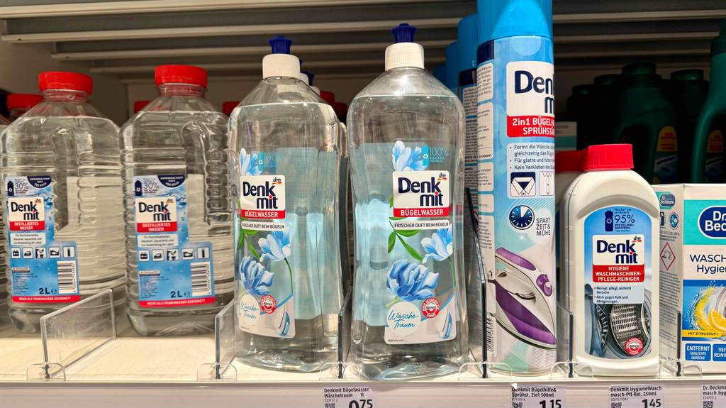 Bügelwasser im Test in der Sprühflasche steht neben weiteren Bügelprodukten in einem Verkaufsregal.