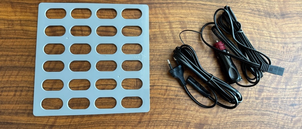 Das Zubehör der Dometic TropiCool TC 21FL liegt auf einem Tisch.