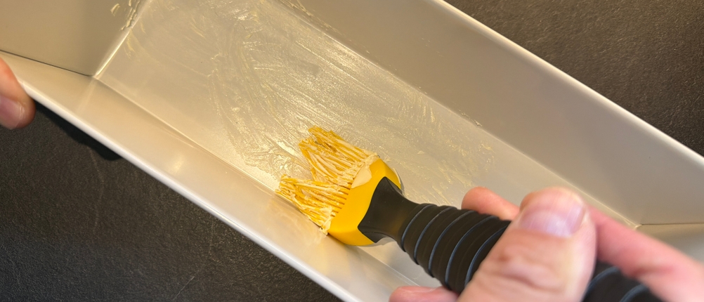 Mit einem Pinsel wird die Brotbackform Dr. Oetker 4855 eingestrichen.