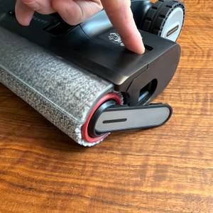 Eine Hand hat die Rolle am Dreame H14 Pro entriegelt