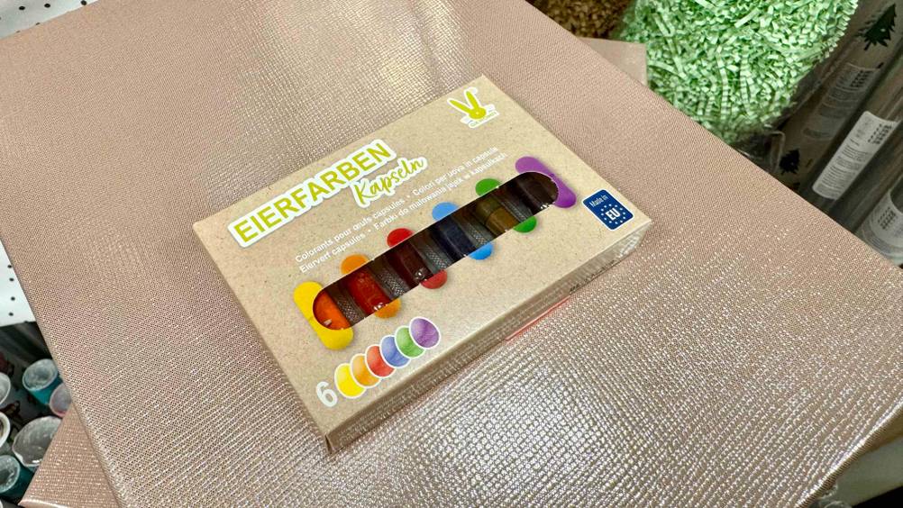 Eine Packung der getesteten Eierfarben auf einer hellen Fläche liegend.