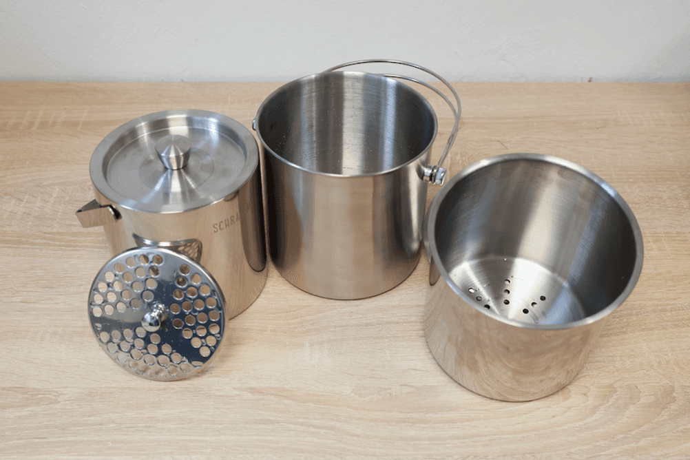 Test der Eiskübel: Auf einem Tisch steht ein Edelstahl-Eiskübel mit Siebgitter und ein Eiskübel mit herausnehmbarem Innenbehälter.