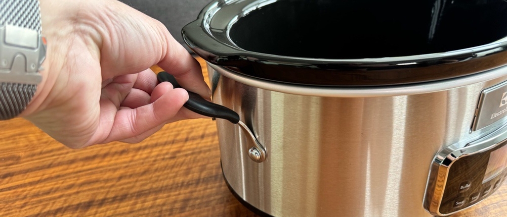 Eine Hand hält den Electrolux ESC7400 am Griff fest