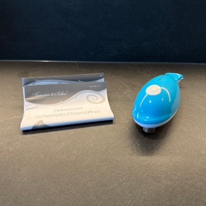 Der elektrische Rosenstein-& Söhne-Sicherheitsdosenöffner liegt neben der Anleitung auf einer Arbeitsplatte