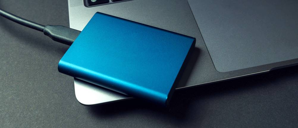 Externe SSD-Festplatte 1TB Test: Eine externe SSD liegt auf einem Laptop.
