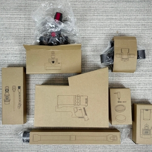 Die Einzelteile des Fabuletta FSV001 liegen in Kartons verpackt auf einem Teppichboden. Jedes Teil ist mit einem Symbol gekennzeichnet.