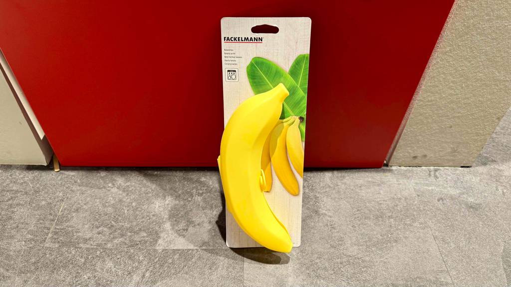 Eine gelbe getestete Bananenbox lehnt mit der Verpackung an einem roten Hocker.