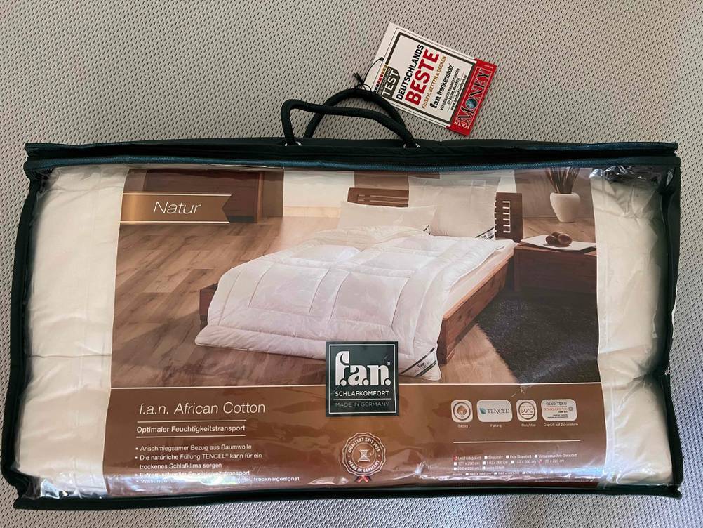 Eine getestete Bettdecke in 155x220 cm in ihrer Originalverpackung auf einer hellen Fläche.