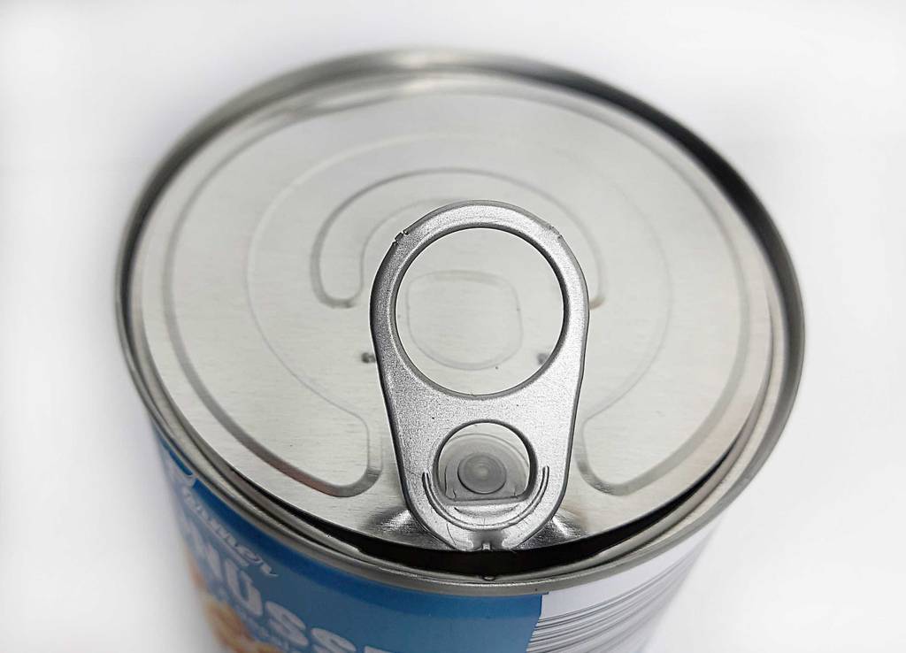 Ansicht von oben auf einen mit Öffnungslasche ausgestatteten Deckel einer Dose inklusive getesteter und gesalzener Erdnüsse.