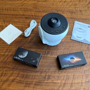 Der Lieferumfang vom Febotak-Aurora-Projektor L03 liegt auf einem Tisch.