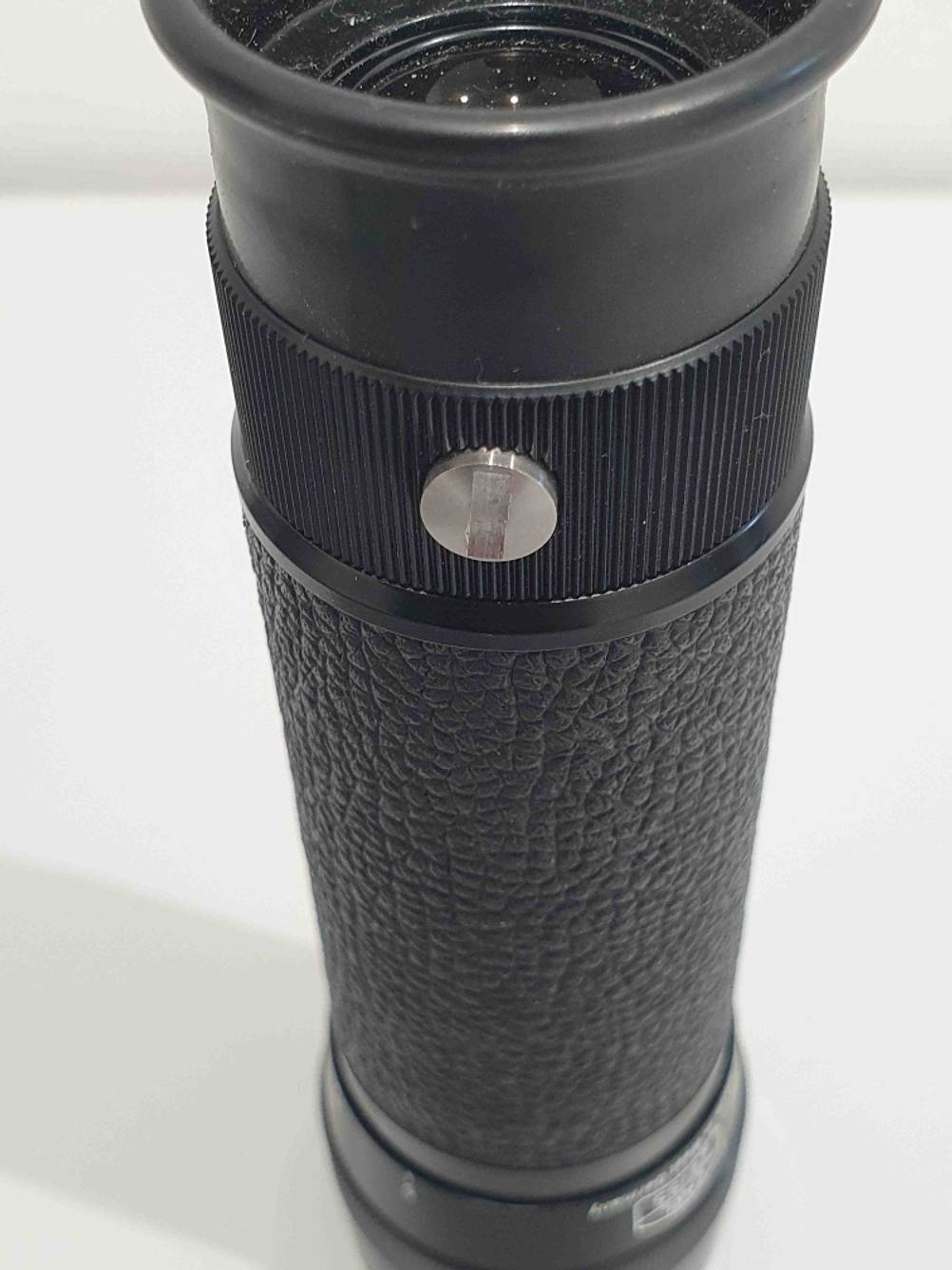 Nahaufnahme einer Einstellschraube auf der Seite eines getesteten Fernrohrs.